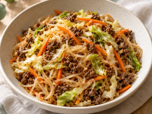 AI-generated serving illustration of Beef & cabbage noodle bowls